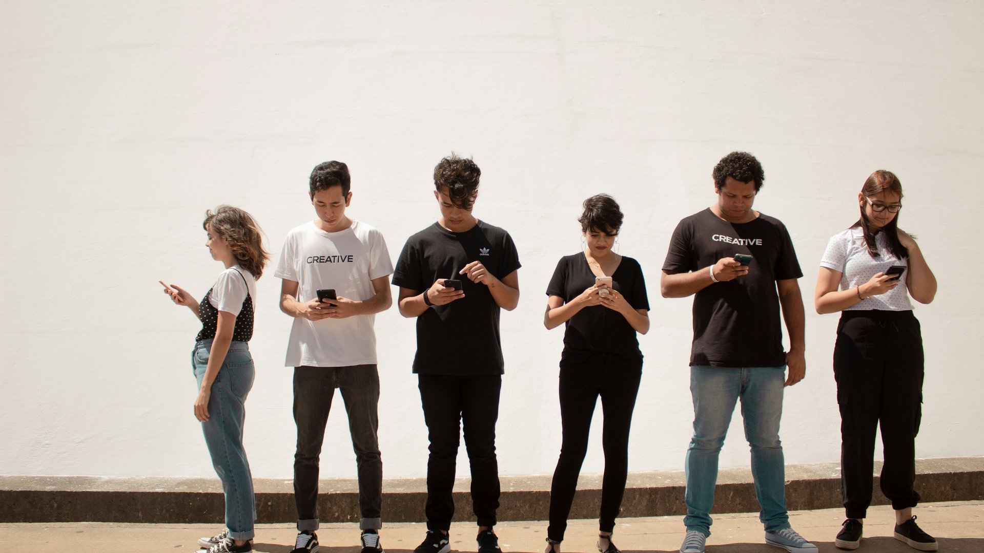 Young people lined up using smart phones